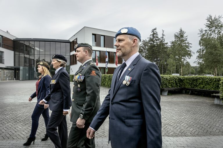 vier veteranen lopen langs het pand van het Nederlands Veteraneninstituut in Doorn